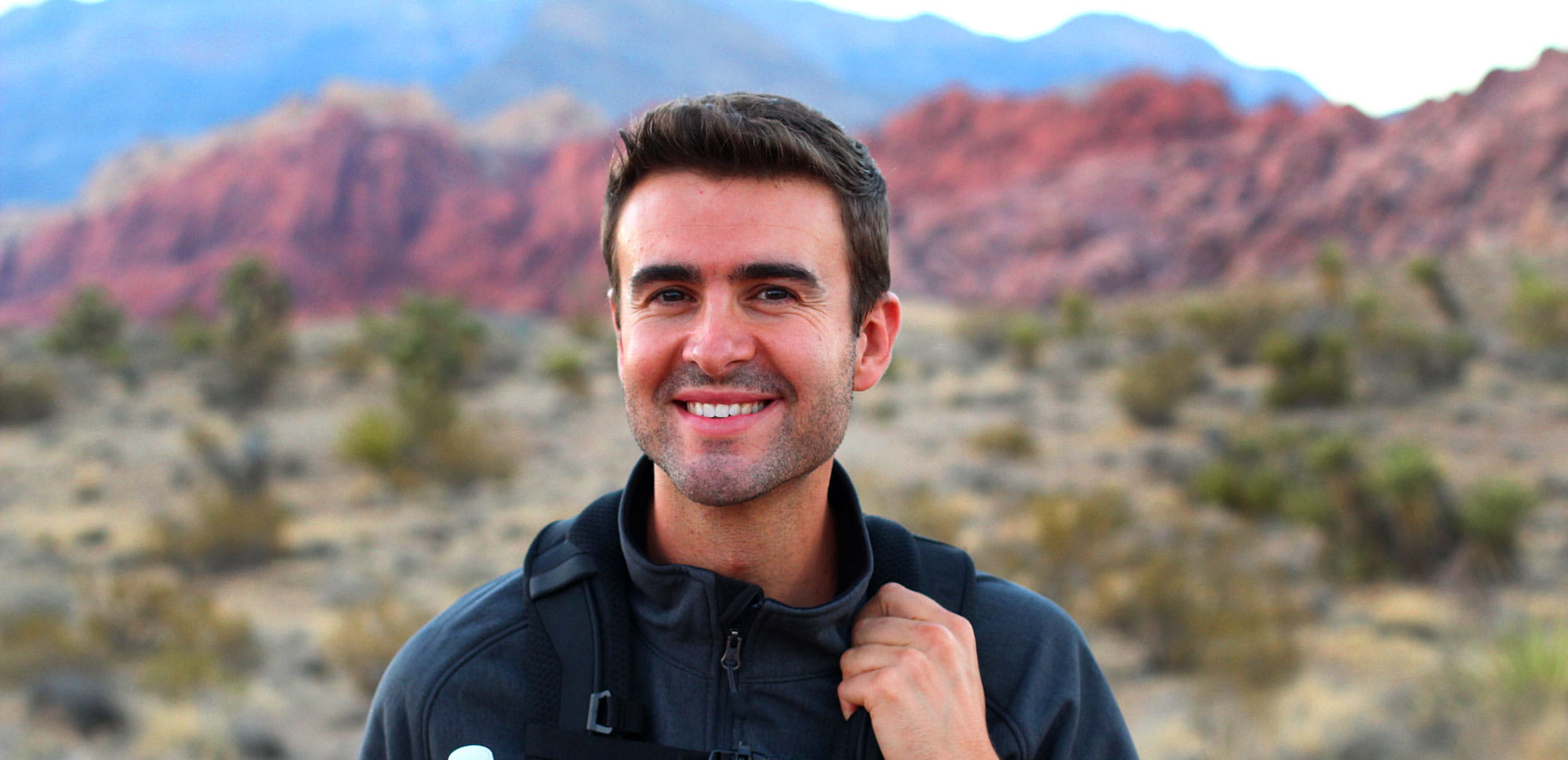 Man in blue coat smiling